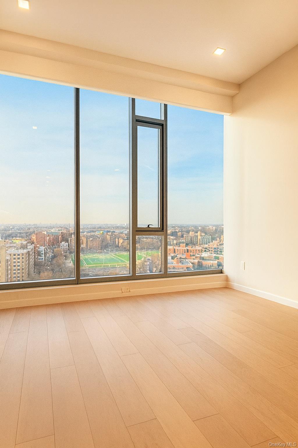 35-32 Leavitt Street, Unit PHK Queens, NY 11354 - Photo 4 of 10 a view of an empty room and window