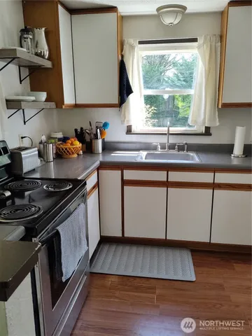 a kitchen with wooden floors and a sink