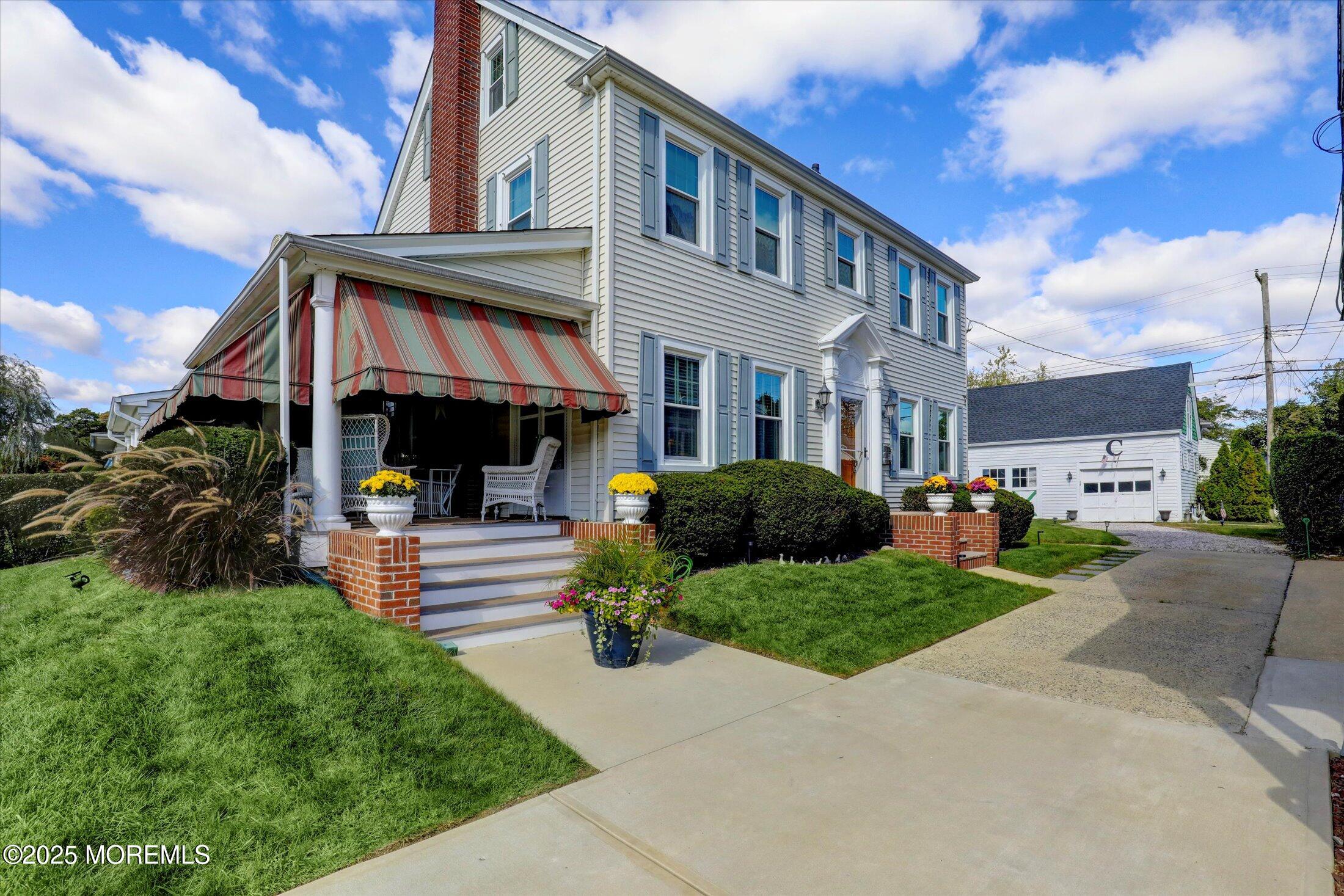 a front view of a house with a yard table and chairs