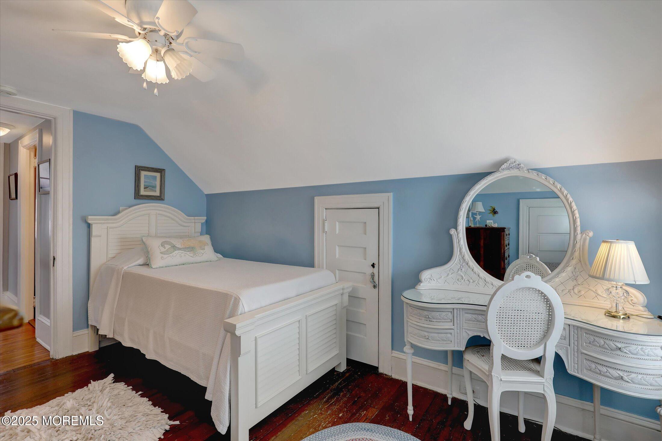 309 Spier Avenue Allenhurst, NJ 07711 - Photo 23 of 32 a bedroom with a bed and a chandelier
