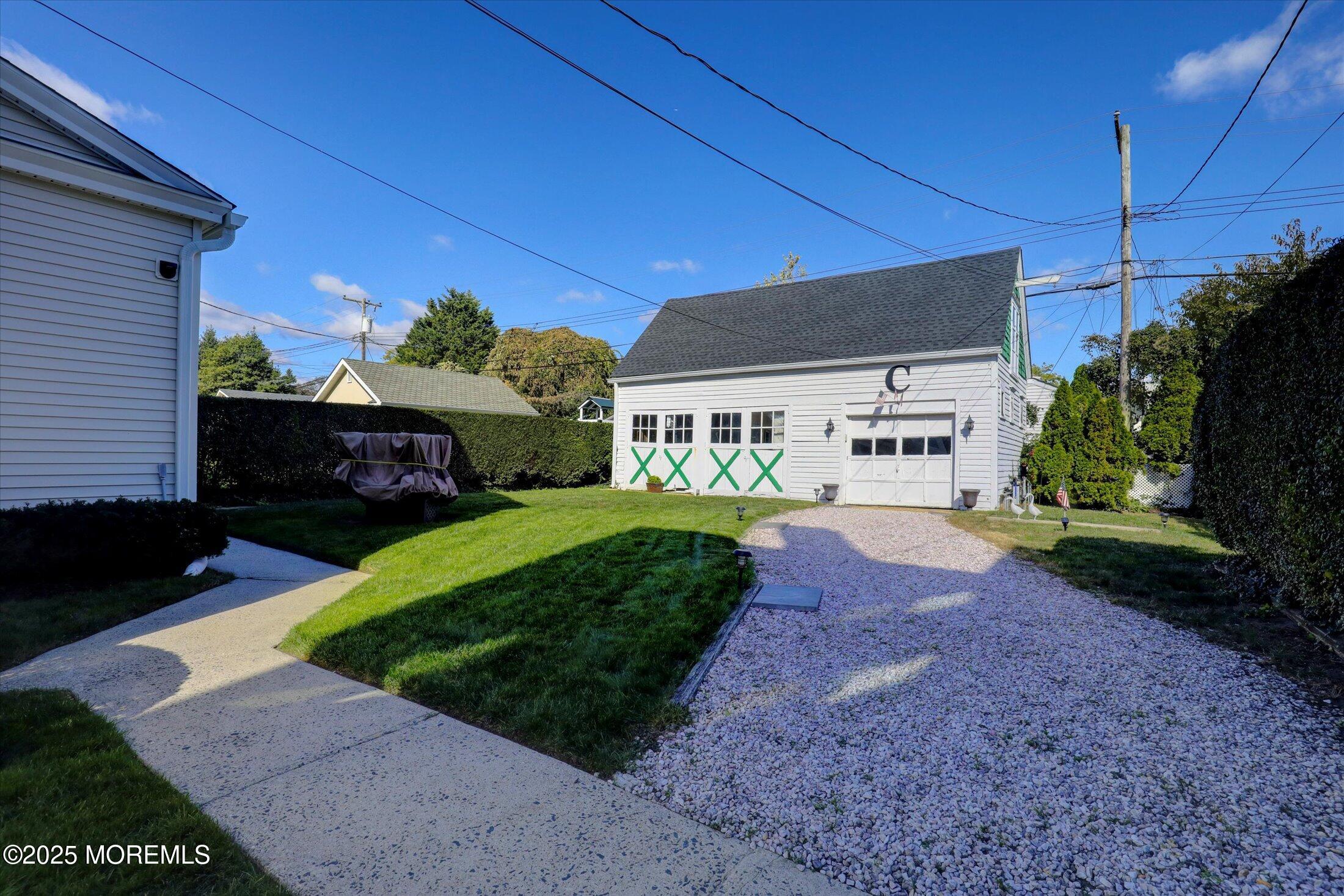 309 Spier Avenue Allenhurst, NJ 07711 - Photo 26 of 32 a front view of a house with a yard and a garage
