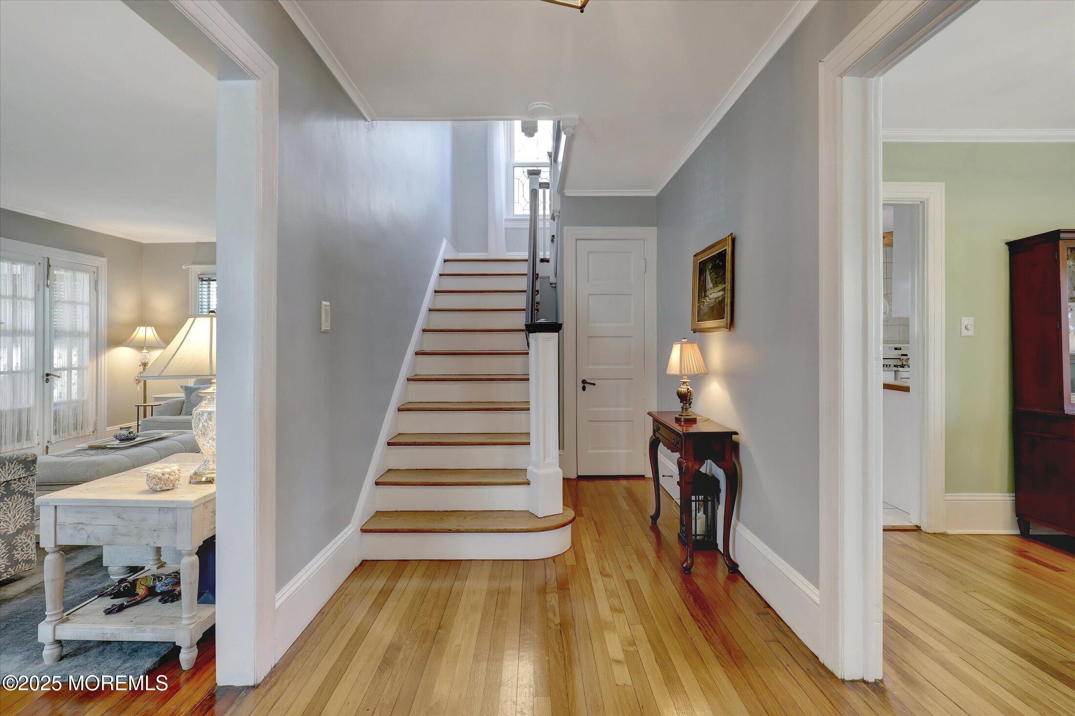309 Spier Avenue Allenhurst, NJ 07711 - Photo 7 of 32 a view of a hallway with wooden floor and staircase