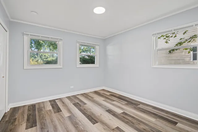 a view of a room with wooden floor and window