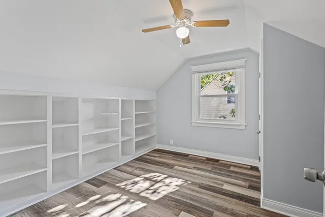 a view of an empty room with a window and closet