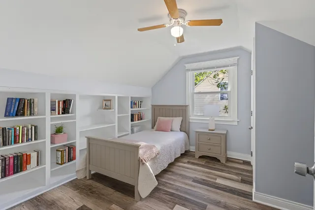a bedroom with a bed and a book shelf