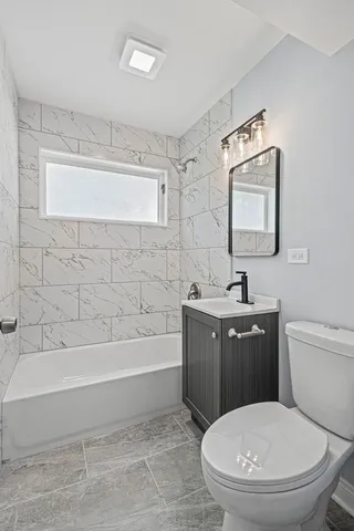 a bathroom with a toilet a sink and bathtub