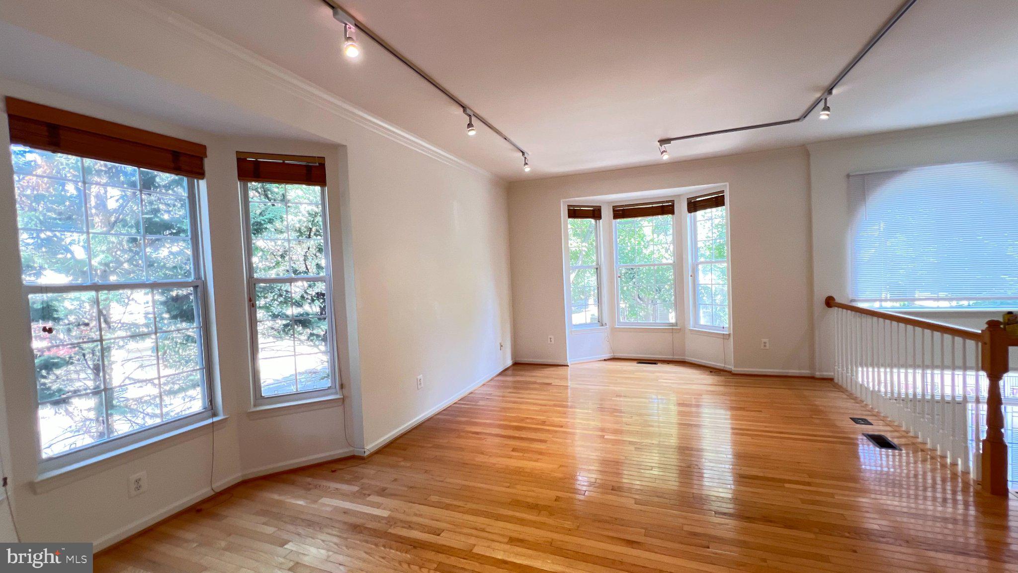 4100 Flower Fairfax, VA 22030 - Photo 7 of 47 a view of an empty room with wooden floor and a window