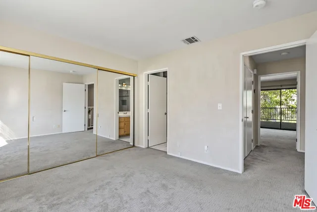 a view of an empty room and a bathroom
