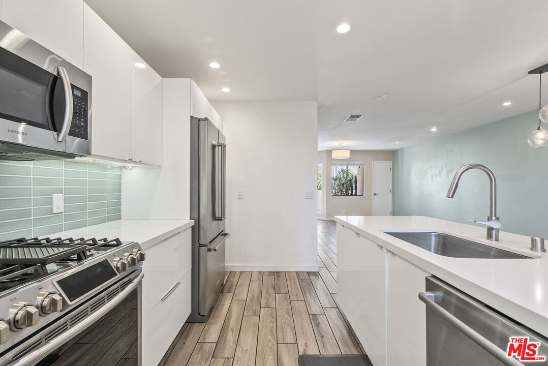 1802 20th Street, Unit B Santa Monica, CA 90404 - Photo 8 of 22 a kitchen with a sink and stainless steel appliances