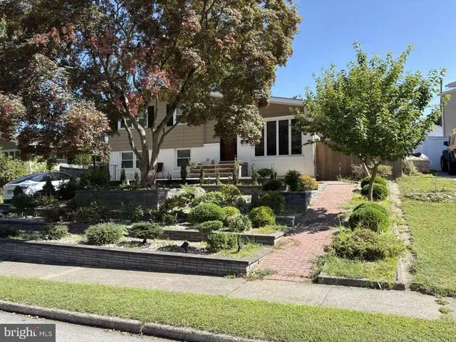 a front view of a house with a yard and outdoor seating