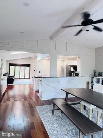 a living room with lots of furniture and wood floor