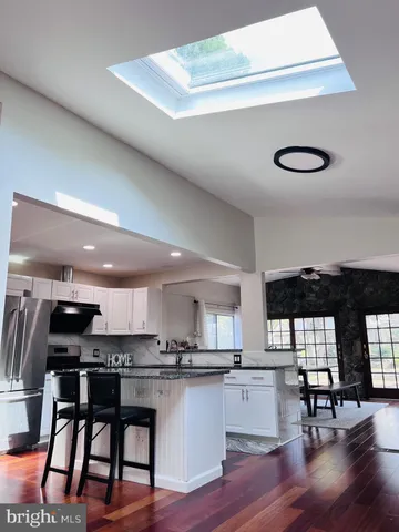 a kitchen with a table chairs window and appliances