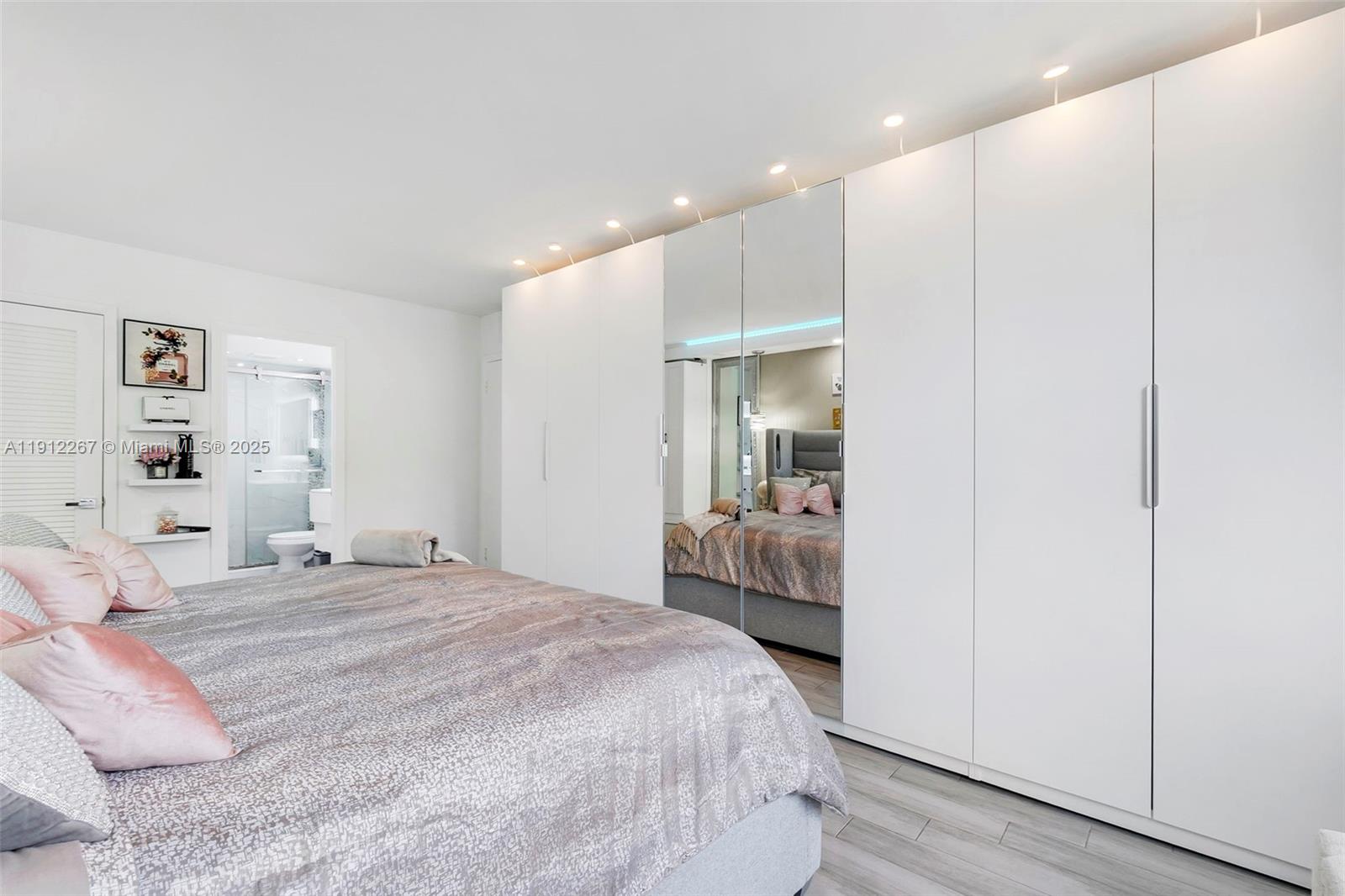 2121 North Ocean Boulevard, Unit 204W Boca Raton, FL 33431 - Photo 20 of 59 a bedroom with a bed and a large mirror