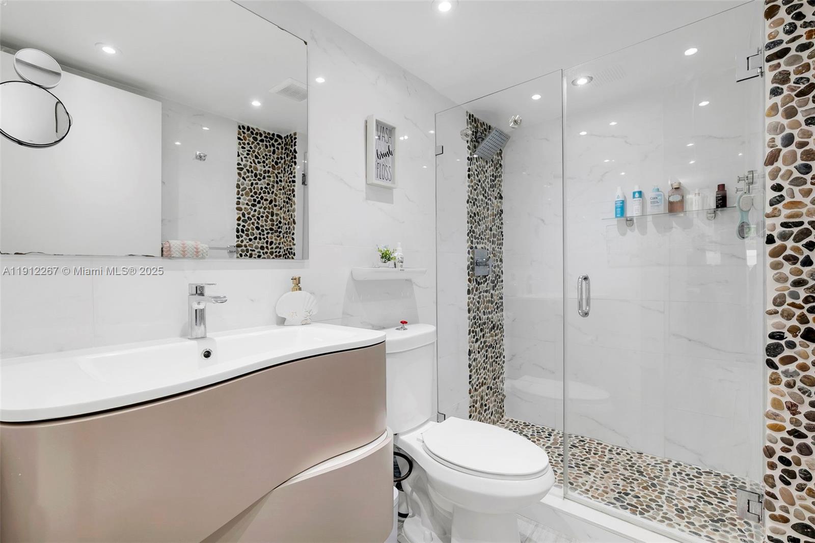 2121 North Ocean Boulevard, Unit 204W Boca Raton, FL 33431 - Photo 25 of 59 a bathroom with a sink a toilet and shower