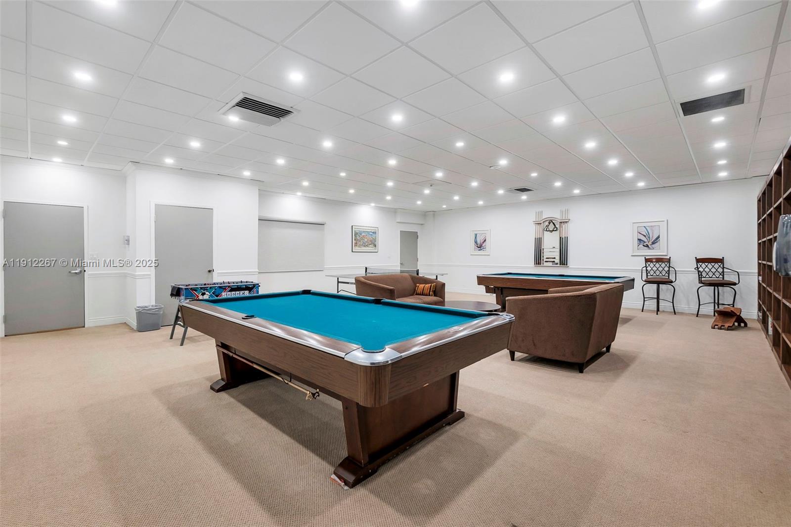 2121 North Ocean Boulevard, Unit 204W Boca Raton, FL 33431 - Photo 39 of 59 a large room with pool table a flat screen tv and couches