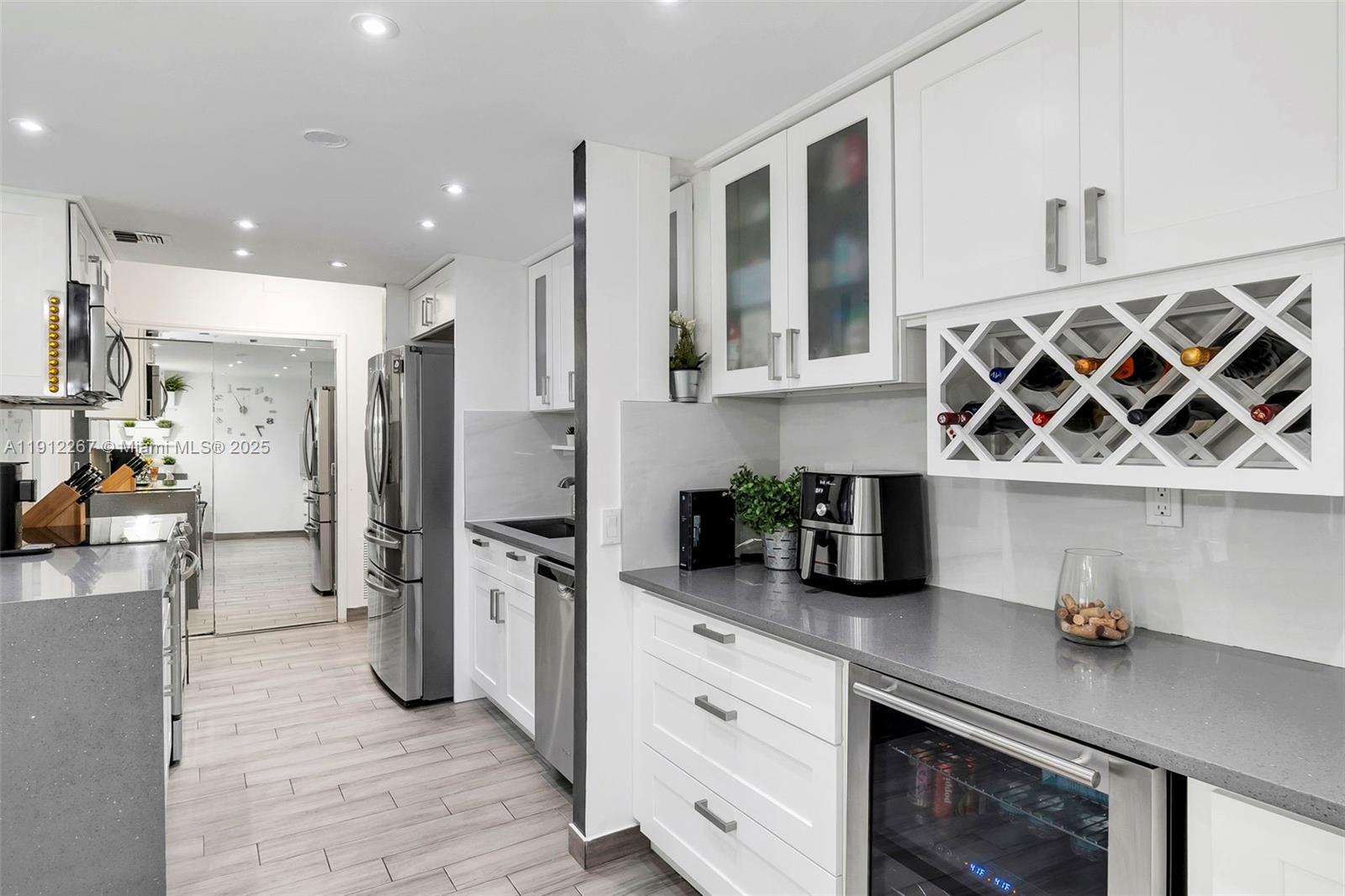 2121 North Ocean Boulevard, Unit 204W Boca Raton, FL 33431 - Photo 7 of 59 a kitchen with stainless steel appliances granite countertop a refrigerator and stove