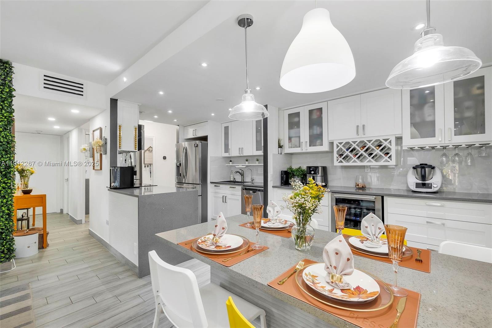 2121 North Ocean Boulevard, Unit 204W Boca Raton, FL 33431 - Photo 9 of 59 a open dining room with furniture a kitchen and chandelier