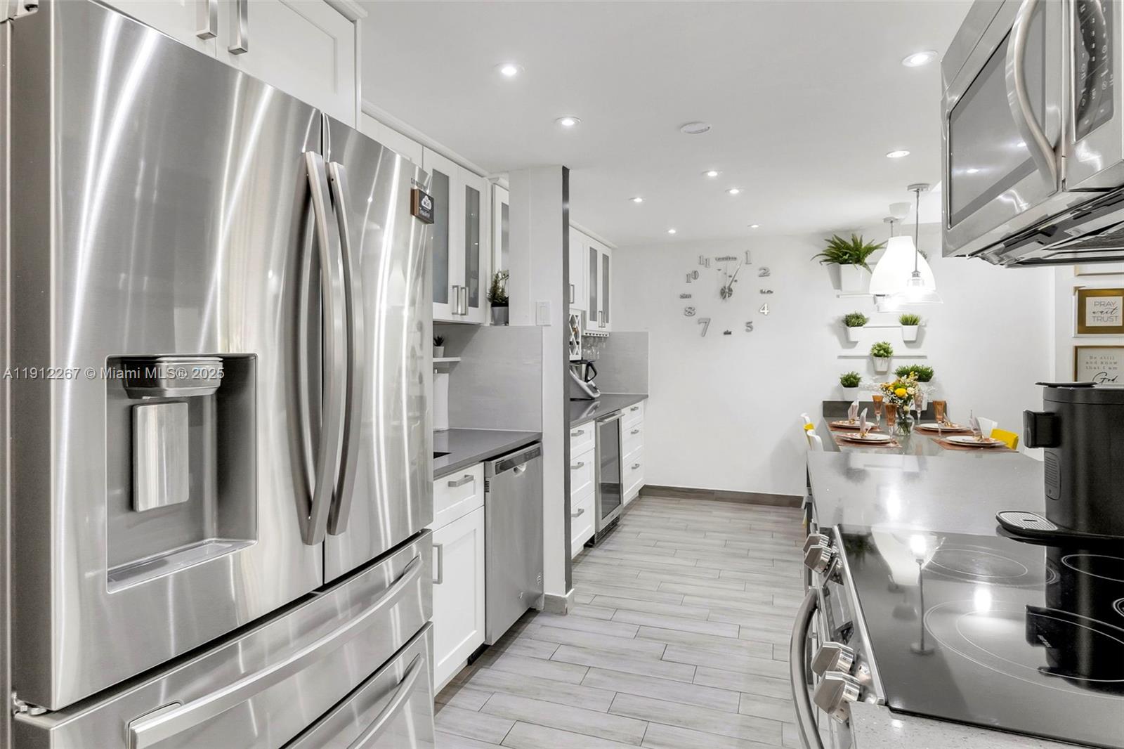 2121 North Ocean Boulevard, Unit 204W Boca Raton, FL 33431 - Photo 10 of 59 a kitchen with stainless steel appliances a refrigerator and a table