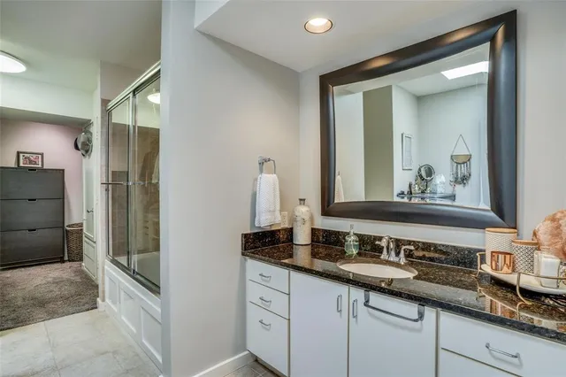 a bathroom with a double vanity sink and a mirror