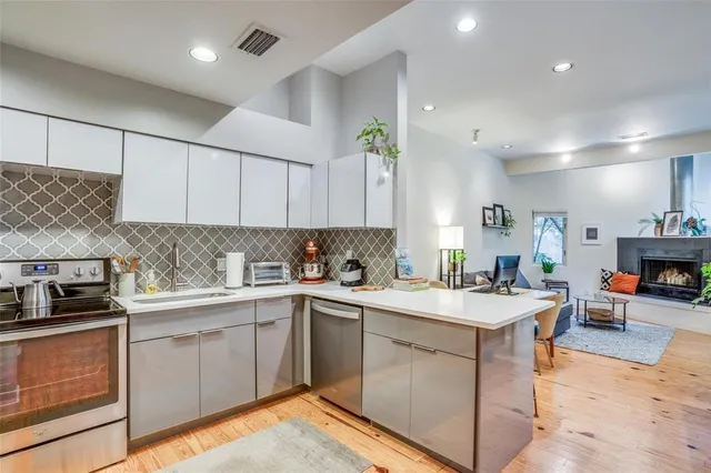 a kitchen with a sink stove and cabinets