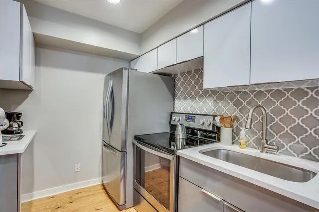a kitchen with a sink and a refrigerator