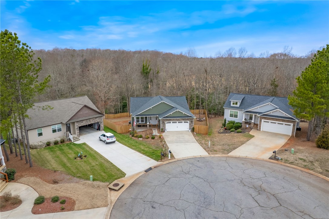 28 Vanessa Rae Lane Pendleton, SC 29670 - Photo 14 of 16 This aerial view showcases a residential street with three distinct homes and attached garages.