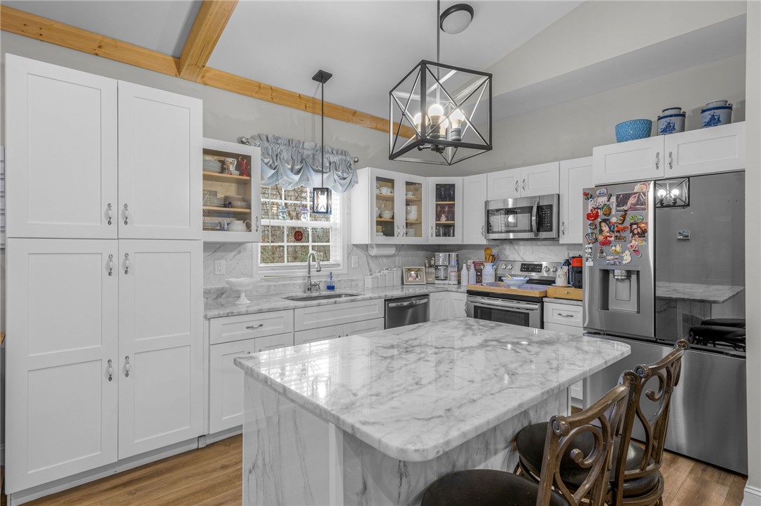 28 Vanessa Rae Lane Pendleton, SC 29670 - Photo 5 of 16 This bright kitchen features sleek white cabinetry and luxurious marbled countertops.