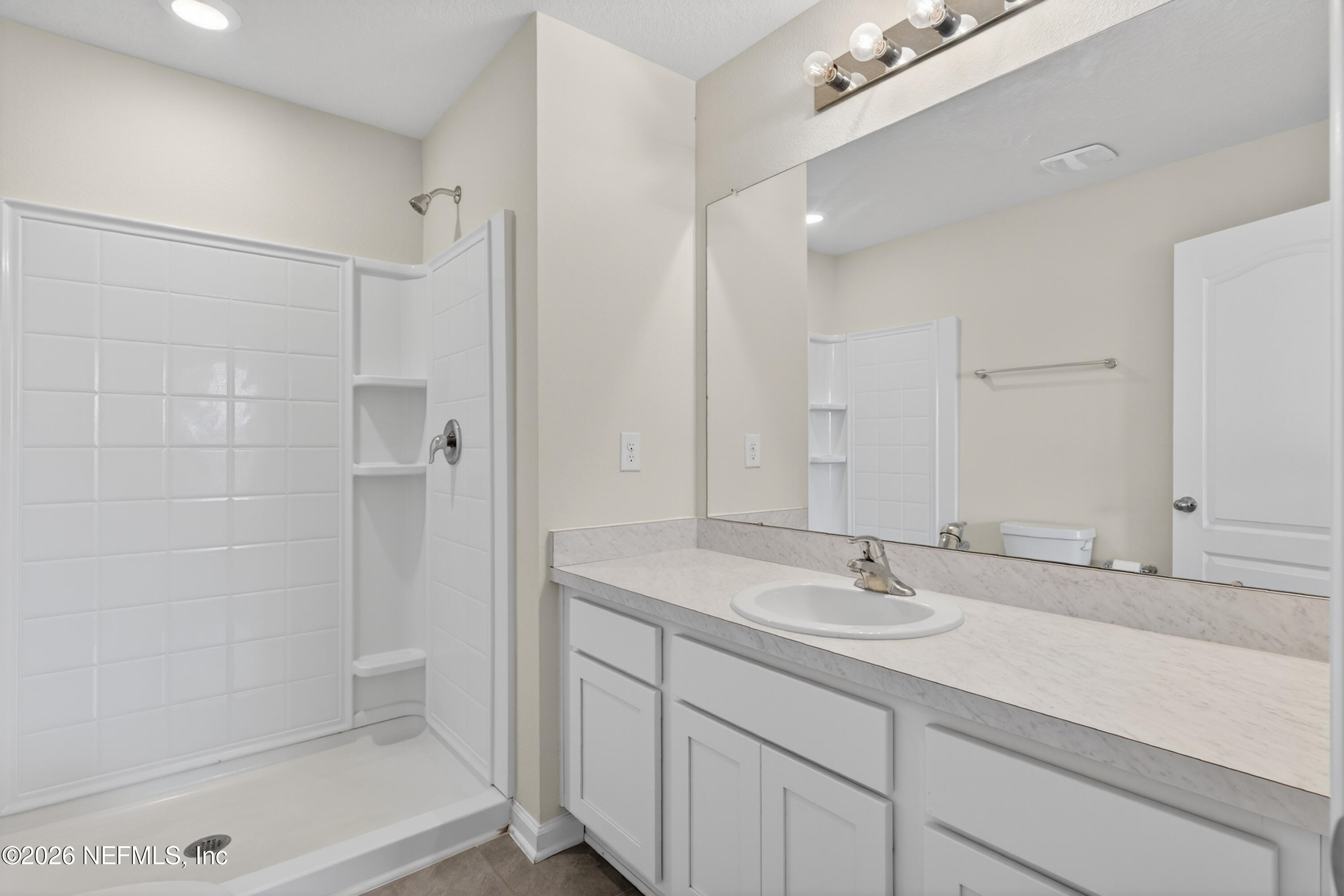 8210 Larose Road Jacksonville, FL 32211 - Photo 26 of 38 a bathroom with a shower sink and mirror