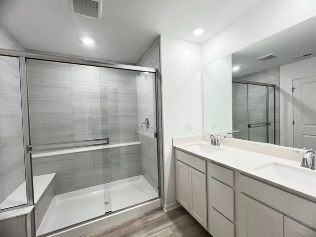 a bathroom with a shower sink and mirror