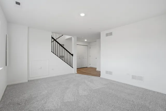 a kitchen with stainless steel appliances a dining table chairs and white cabinets