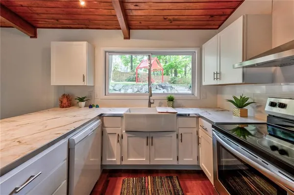 a kitchen with a sink stove and cabinets