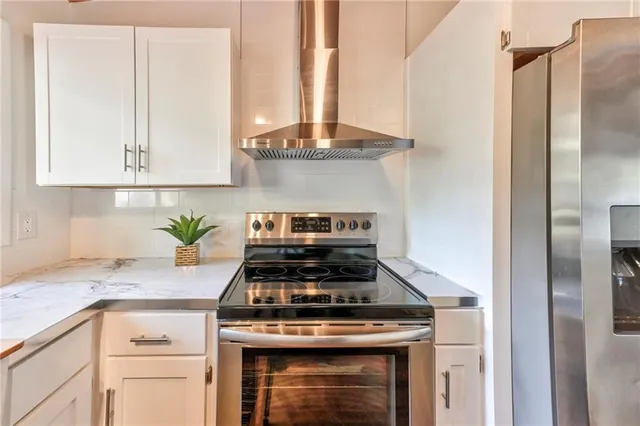 a stove top oven sitting inside of a kitchen