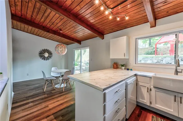 a view of a kitchen and wooden floor