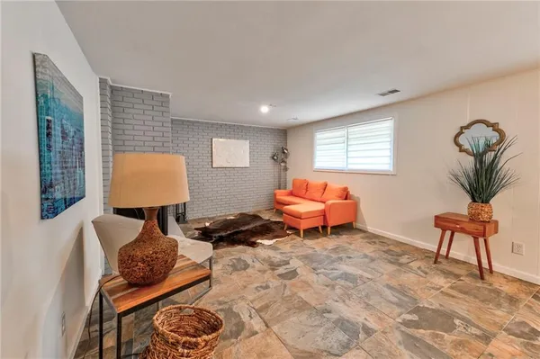 a living room with furniture and a lamp