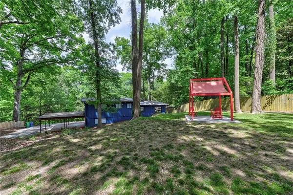 a front view of a house with a yard and trees