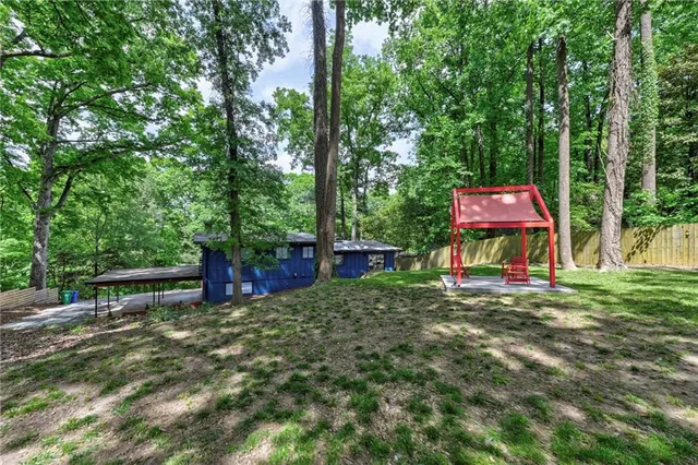 a front view of a house with a yard and trees
