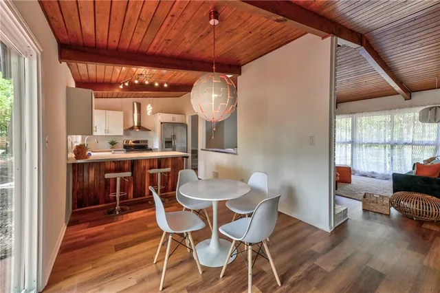 a dining room with furniture and wooden floor