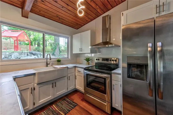 a kitchen with a sink stove and refrigerator