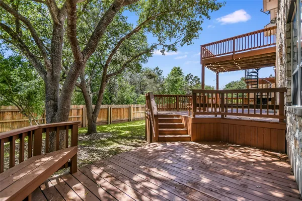 a backyard of a house with wooden floor and outdoor seating
