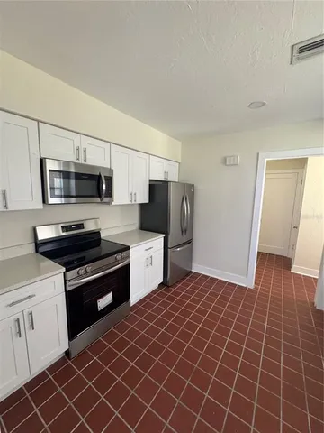 a kitchen with stainless steel appliances a stove a sink and a refrigerator