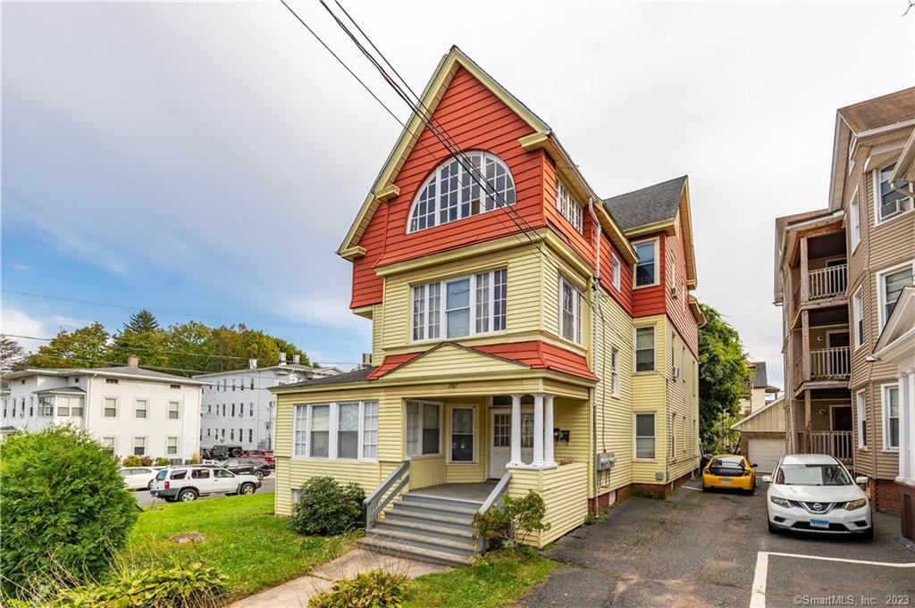 357 Chestnut Street New Britain, CT 06051 - Photo 1 of 1 a front view of a residential apartment building with a yard