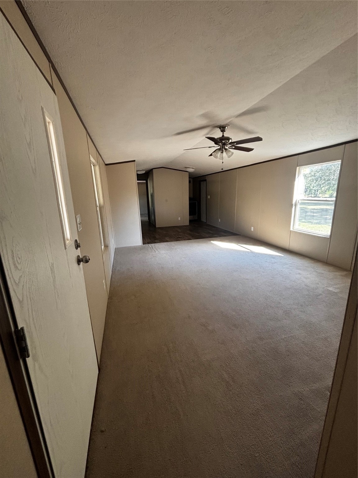 10 South Walnut Lake Drive Huntsville, TX 77320 - Photo 10 of 12 a view of a livingroom with a ceiling fan and window