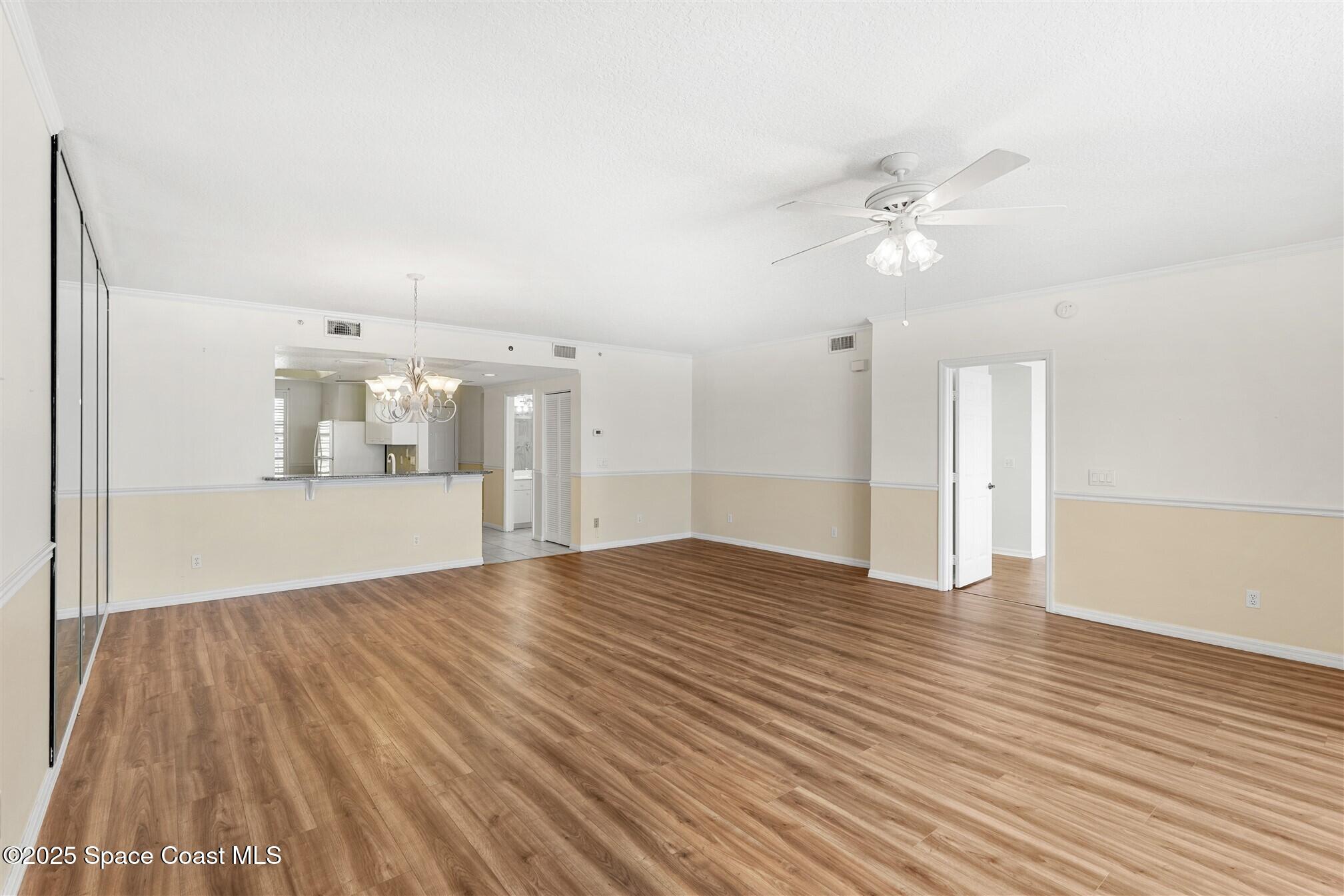 104 Riverside Drive, Unit 402 Cocoa, FL 32922 - Photo 13 of 41 a view of empty room with wooden floor and fan