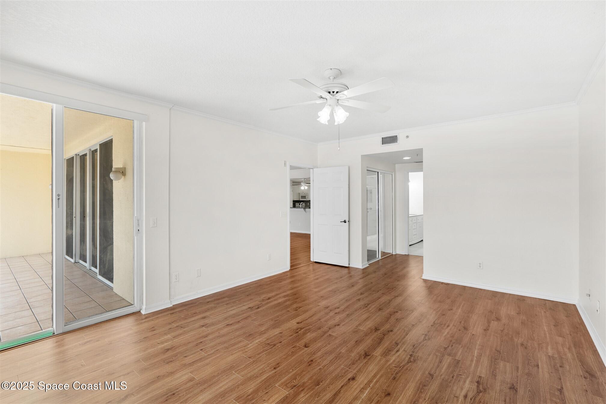 104 Riverside Drive, Unit 402 Cocoa, FL 32922 - Photo 15 of 41 wooden floor in an empty room with a window