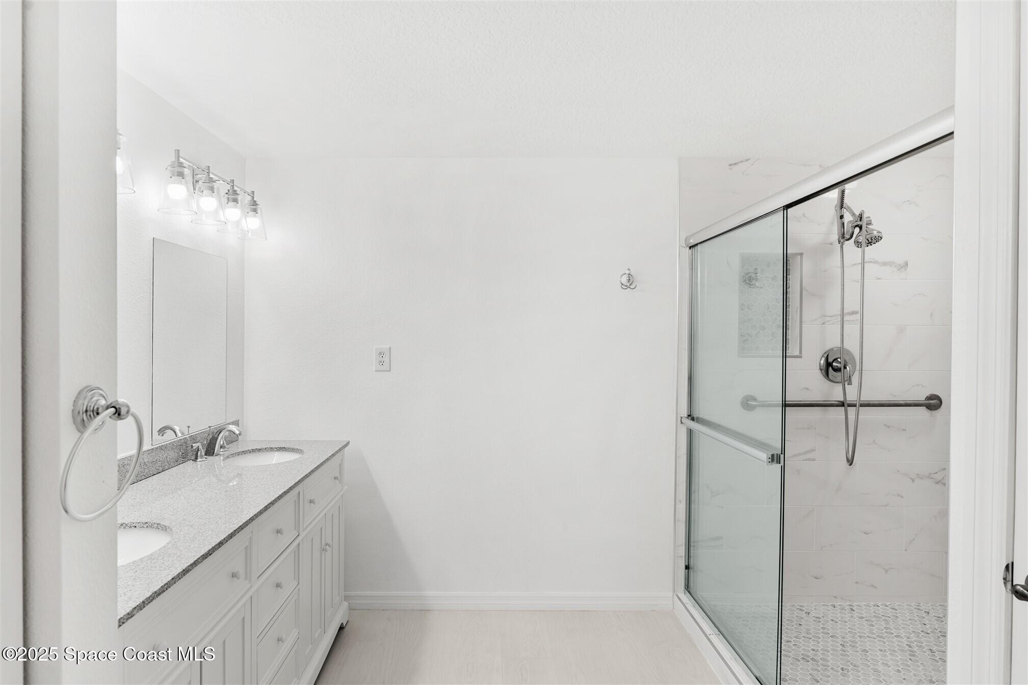 104 Riverside Drive, Unit 402 Cocoa, FL 32922 - Photo 17 of 41 a bathroom with a sink and a mirror
