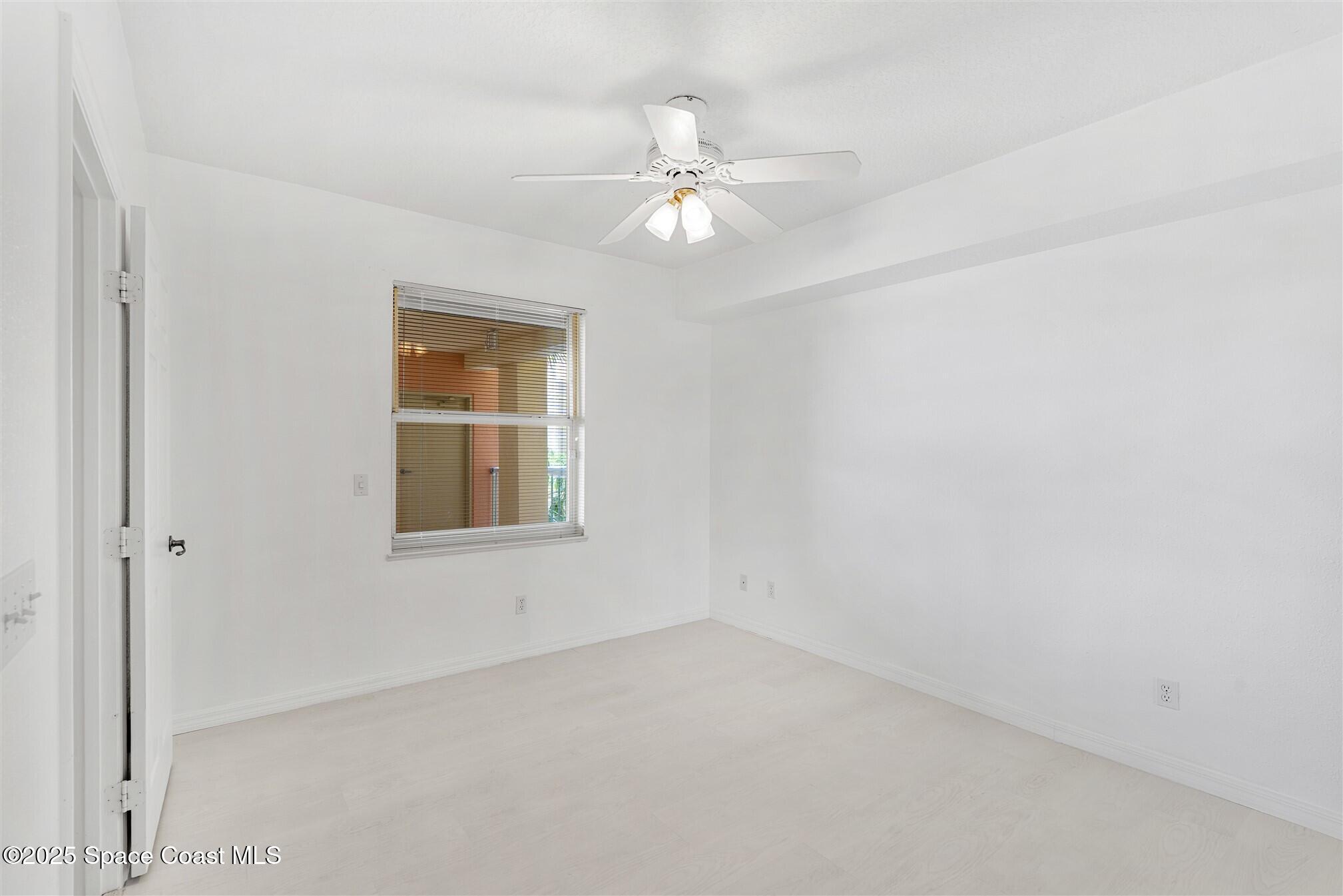 104 Riverside Drive, Unit 402 Cocoa, FL 32922 - Photo 19 of 41 an empty room with a window and a fan