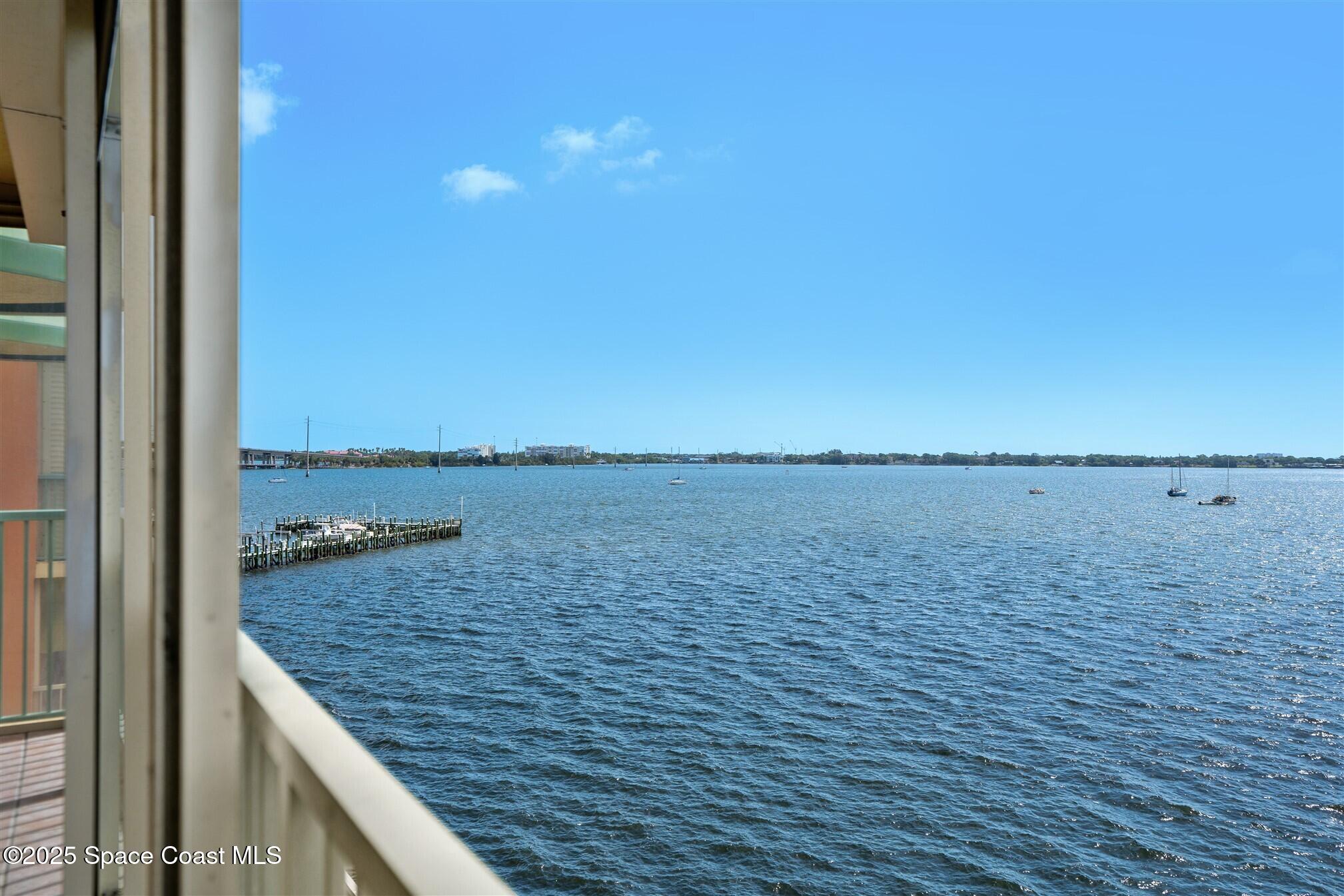 104 Riverside Drive, Unit 402 Cocoa, FL 32922 - Photo 23 of 41 a view of a wooden floor and lake