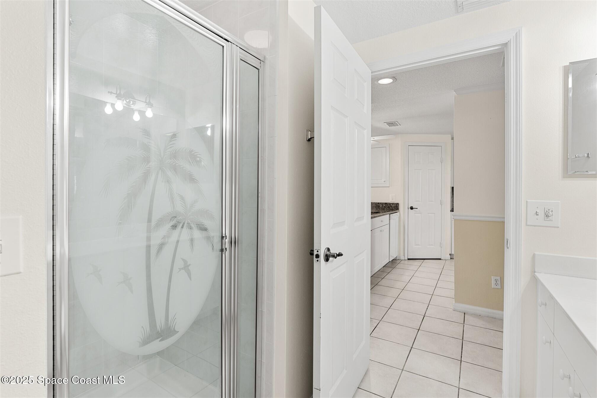 104 Riverside Drive, Unit 402 Cocoa, FL 32922 - Photo 7 of 41 a bathroom with a glass shower door