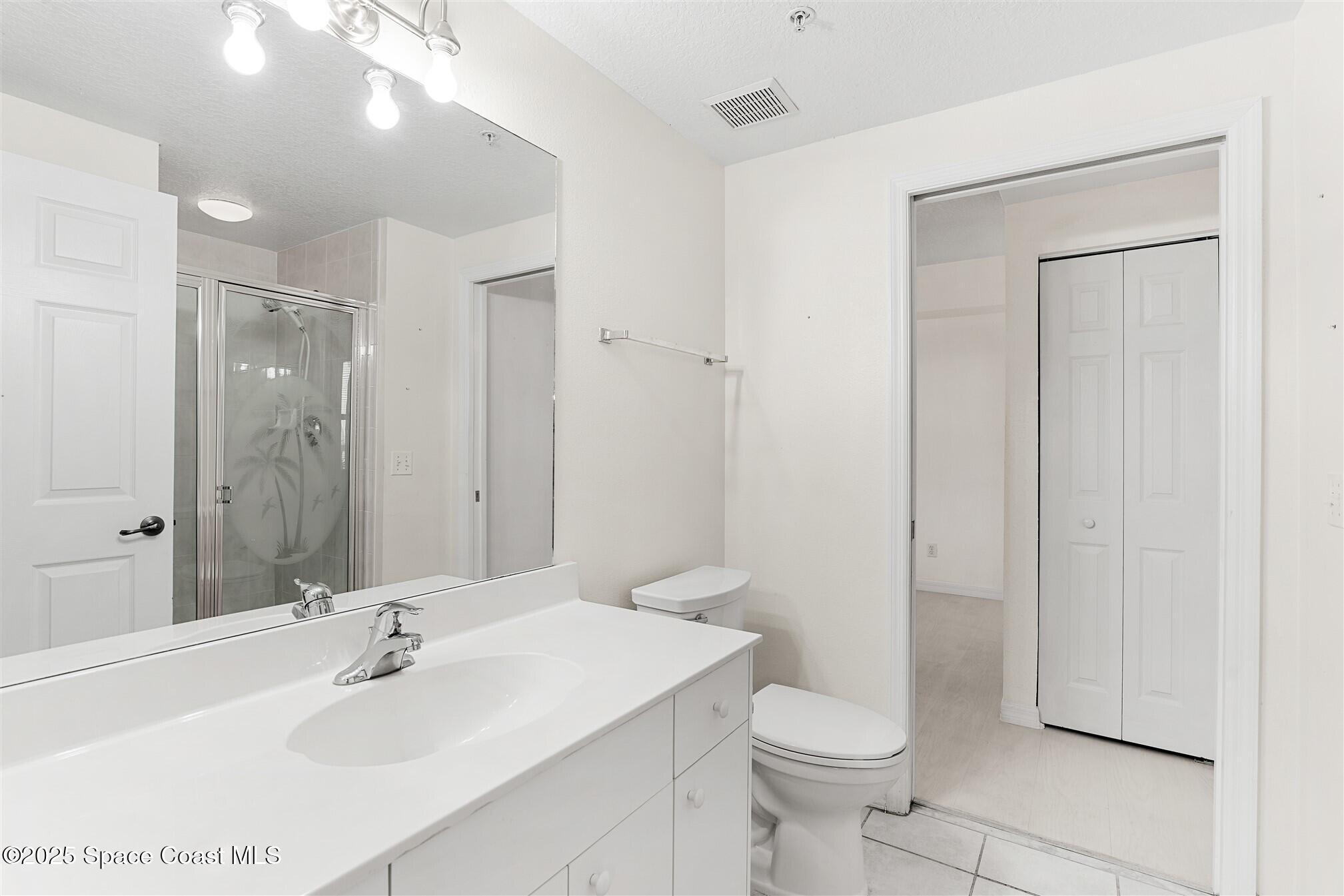 104 Riverside Drive, Unit 402 Cocoa, FL 32922 - Photo 8 of 41 a bathroom with a sink toilet and shower