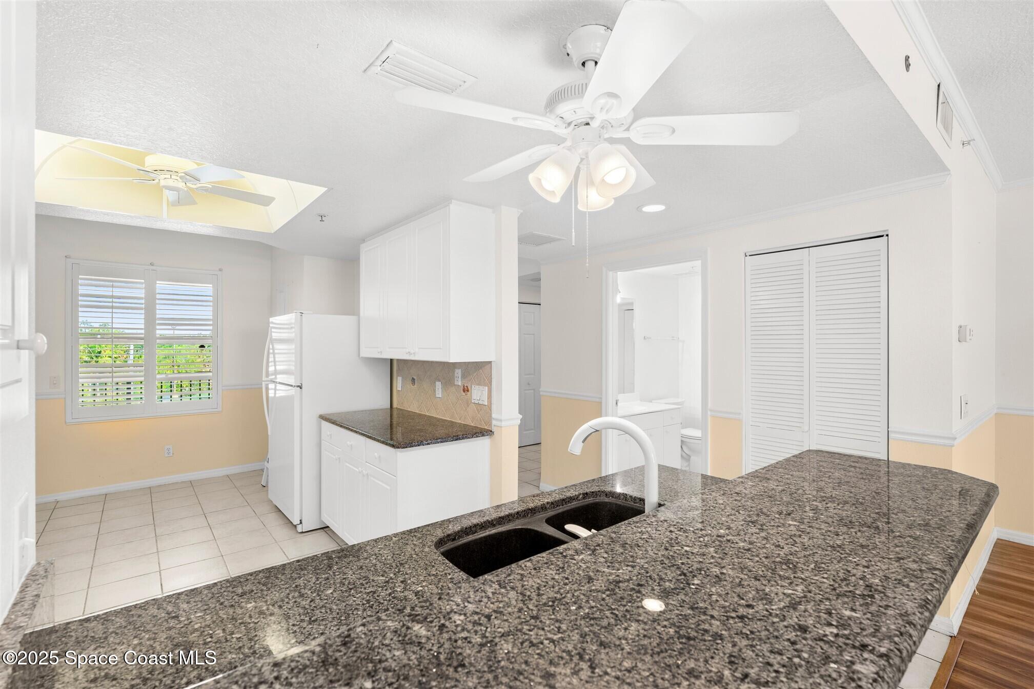 104 Riverside Drive, Unit 402 Cocoa, FL 32922 - Photo 9 of 41 a living room with a couch and a chandelier